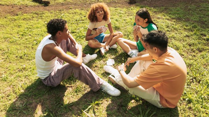 a group of people sitting on the grass